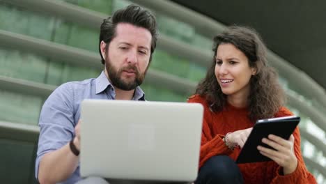 Couple-using-digital-devices-together